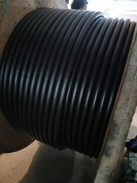 Black cable wound on an Elite Cables production drum